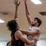 ECCs Damon Gaither (32) and ECCs Elyon Zevenbergen (34) fight for the ball during a mens game between the Everett Community College Trojans and Edmonds College Tritons at Seaview Gymnasium at Edmonds College in Lynnwood, Washington on Wednesday Jan. 25, 2023. The Tritons won, 91-84. (Annie Barker / The Herald)