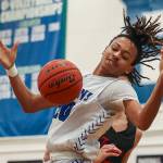 EC’s Damajio Merritt (20) fights for the ball during a men’s game between the Everett Community College Trojans and Edmonds College Tritons at Seaview Gymnasium at Edmonds College in Lynnwood, Washington on Wednesday Jan. 25, 2023. The Tritons won, 91-84. (Annie Barker / The Herald)