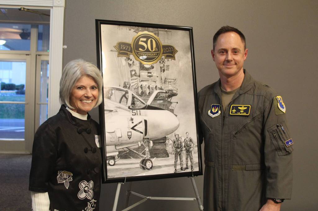 Tonya Clark and her son, Brigadier General Tad Clark, receive a painting of their husband and father, bombardier Robert Clark, with his pilot, Michael McCormick, who were shot down over North Vietnam in 1973. (Karina Andrew / Whidbey News-Times)
