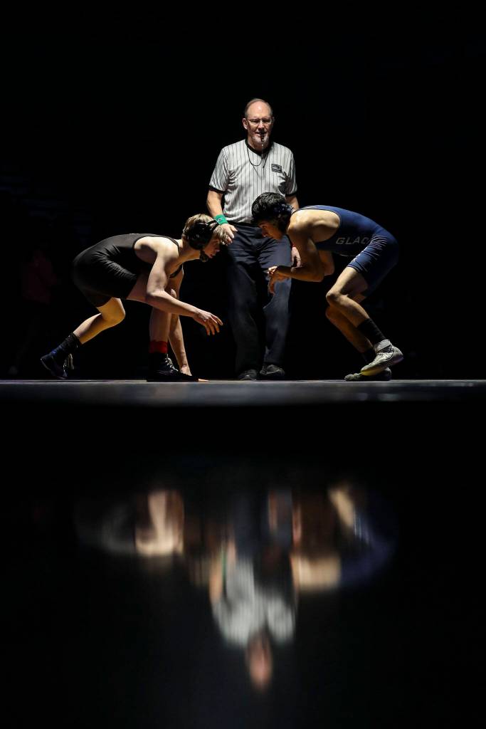 Lake Stevens Jacob Christianson and Glacier Peaks Ulysses Lopez-Vazquez wrestle during the 120 pound weight class match at Lake Stevens High School on Thursday Jan. 26, 2023. (Annie Barker / The Herald)