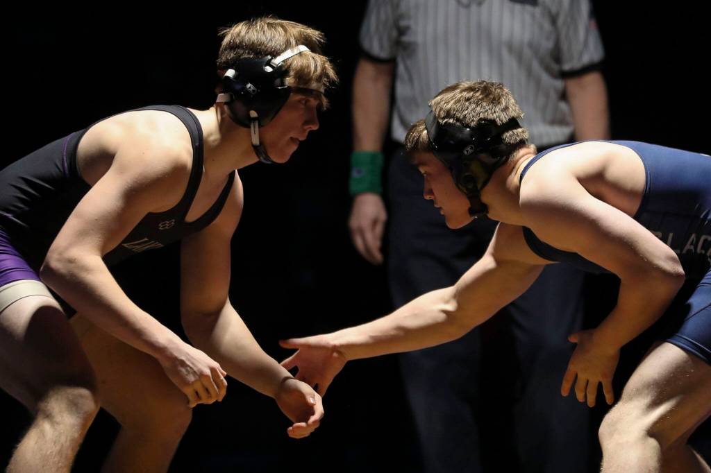 Lake Stevens Brandon Resor and Glacier Peaks Gil Mossburg wrestle at Lake Stevens High School on Thursday Jan. 26, 2023. (Annie Barker / The Herald)