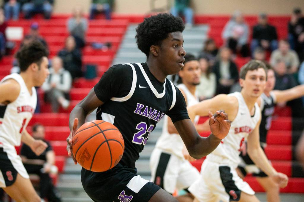 Kamiak senior Josiah Pierre looks for space while pushing the ball up court during a matchup against Snohomish on Saturday, Jan. 28, 2023, in Snohomish, Washington. (Ryan Berry / The Herald)