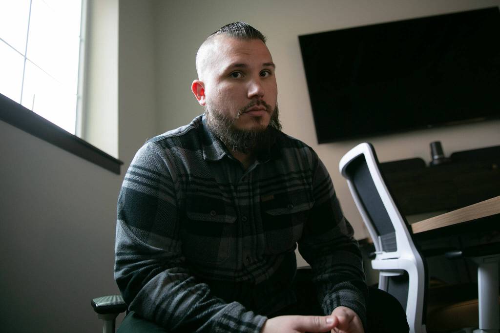 Nathanael Engen, founder of Black Forest Mushrooms, sits in a conference room at Think Tank Cowork on Jan. 27, in downtown Everett. (Ryan Berry / The Herald)