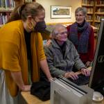 Left to right, Northwest Room Librarian Lisa Labovitch, 41, and contributors to HistoryLink, an online encyclopedia on Washington history, David Cameron, 81, and Louise Lindgren, 79, pose for a photo on Jan. 19, at the Everett Public Library. (Annie Barker / The Herald)