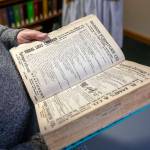 Bob Mayer, 76, holds a book that contributors use for HistoryLink, an online encyclopedia on Washington history, on Jan. 19, at the Everett Public Library. (Annie Barker / The Herald)