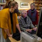 Left to right, Northwest Room Librarian Lisa Labovitch, 41, and contributors to HistoryLink, an online encyclopedia on Washington history, David Cameron, 81, and Louise Lindgren, 79, pose for a photo at the Everett Public Library in Everett, Washington on Thursday, Jan. 19, 2023. (Annie Barker / The Herald)