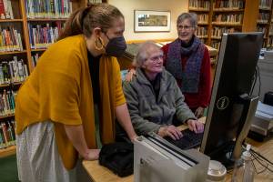 Left to right, Northwest Room Librarian Lisa Labovitch, 41, and contributors to HistoryLink, an online encyclopedia on Washington history, David Cameron, 81, and Louise Lindgren, 79, pose for a photo at the Everett Public Library in Everett, Washington on Thursday, Jan. 19, 2023. (Annie Barker / The Herald)