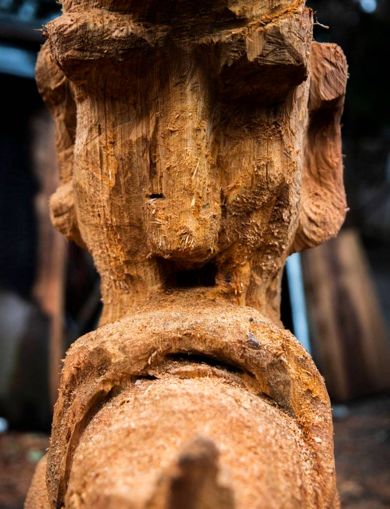 Small splinters of wood stick off of the face of a moon carving by Steve Backus. (Olivia Vanni / The Herald)