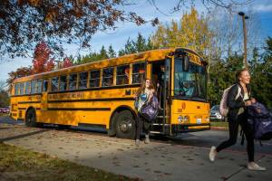The Lake Stevens district swim team gets off their buss for swim practice at Explorer Middle School on Nov. 6, 2019 in Everett, Wash. (Olivia Vanni / The Herald)