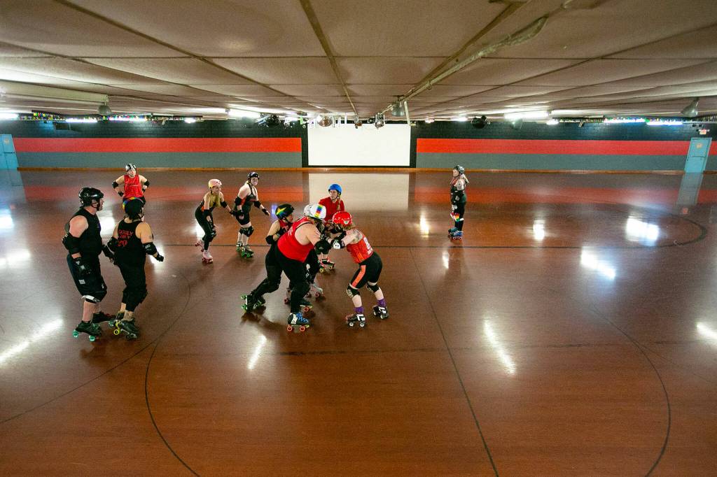 Players run through a number of drills on the flat track floor during a Strawberry City Roller Derby practice at Marysville Skate Center on Monday, Feb. 6, in Marysville. (Ryan Berry / The Herald)