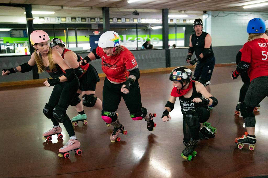 Rose Misconduct Ciara Jay, wearing a star helmet, plays as the jammer and tries to pass blockers on the other team during a Strawberry City Roller Derby practice at Marysville Skate Center on Monday, Feb. 6, in Marysville. (Ryan Berry / The Herald)