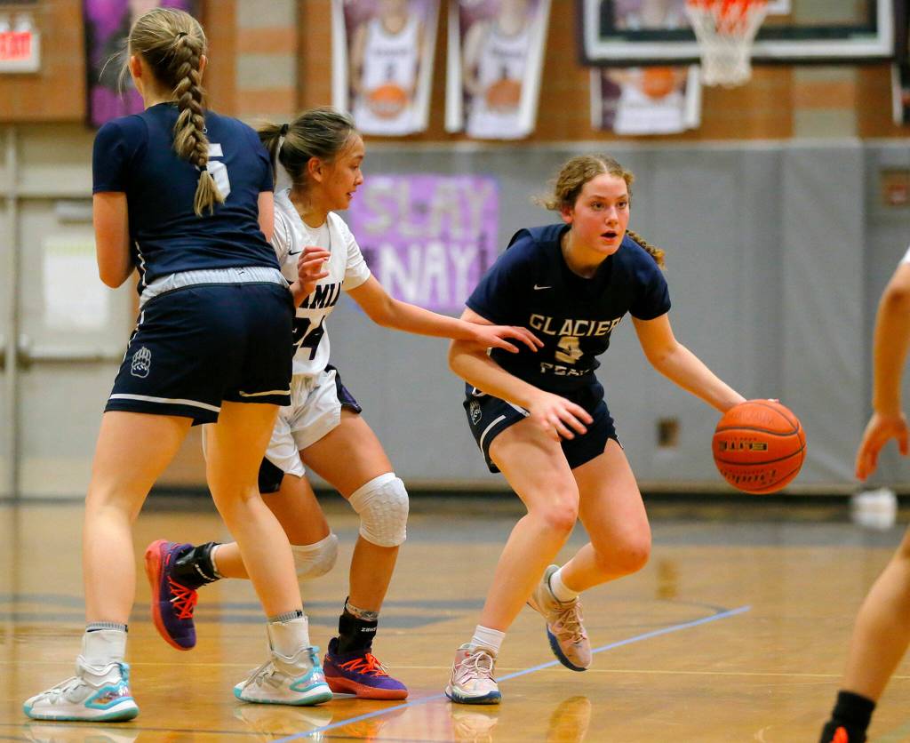 Glacier Peaks Brynna Pukis looks to keep the ball against Kamiak on Wednesday, Feb 1, 2023, at Kamiak High School in Mukilteo, Washington. (Ryan Berry / The Herald)