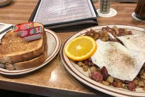 The Totem hash -- corned beef, potatoes and onions, topped with fried eggs -- at Totem Family Diner in Everett, (Mark Carlson / The Herald)