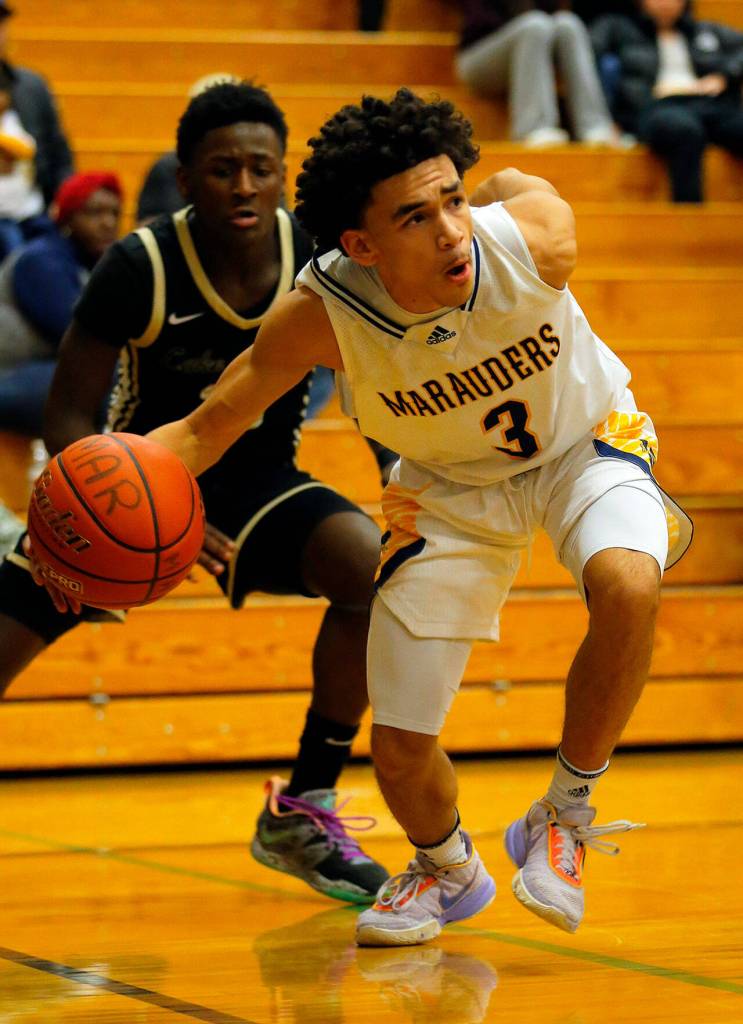 Mariners Macky James tiptoes the line after getting past a defender against Lake Stevens on Thursday, Feb. 2, 2023, at Mariner High School in Everett, Washington. (Ryan Berry / The Herald)