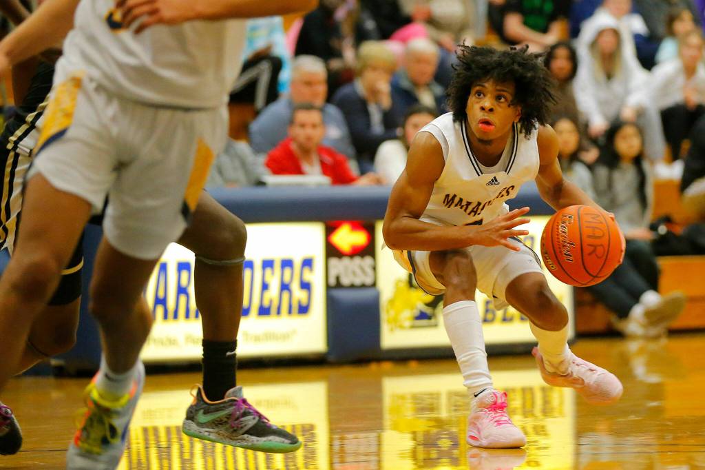 Mariners Jailin Johnson changes direction at the top of the key against Lake Stevens on Thursday, Feb. 2, 2023, at Mariner High School in Everett, Washington. (Ryan Berry / The Herald)