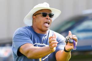 Mark Stewart, head coach, demonstrates proper technique during practice Thursday afternoon at Mariner High School in Everett on August 22, 2019. (Kevin Clark / The Herald)