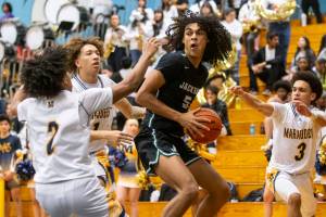 Multiple Mariner players surround Jackson’s Sylas Williams to block his shot during the game on Wednesday, Jan. 4, 2023 in Everett, Washington. (Olivia Vanni / The Herald)