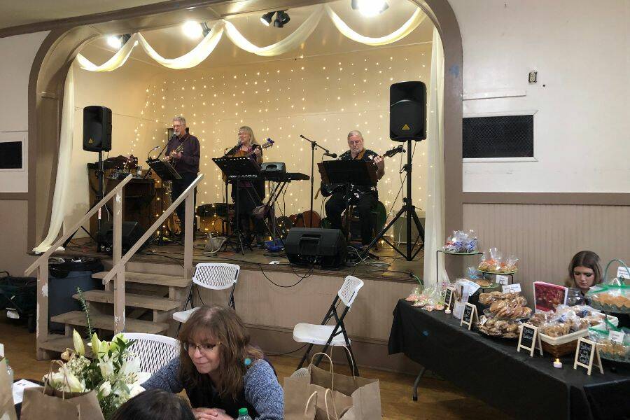 Tom and Jill Hudon, and John Salyer perform for the crowd at the Granite Falls Food Banks Empty Bowl fundraiser Saturday, Feb. 11, in Granite Falls. (Joy Borkholder / The Herald)