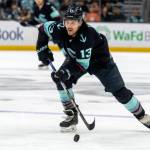 Seattle Kraken forward Brandon Tanev skates with the puck during an NHL hockey game against the New York Islanders, Sunday, Jan. 1, 2023, in Seattle. The Kraken won 4-1. (AP Photo/Stephen Brashear)