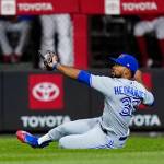 Toronto Blue Jays right fielder Teoscar Hernandez cannot hang onto a single by Philadelphia Phillies' Kyle Schwarber during the fifth inning of a baseball game, Tuesday, Sept. 20, 2022, in Philadelphia. (AP Photo/Matt Slocum)
