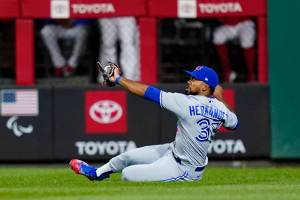 Toronto Blue Jays right fielder Teoscar Hernandez cannot hang onto a single by Philadelphia Phillies' Kyle Schwarber during the fifth inning of a baseball game, Tuesday, Sept. 20, 2022, in Philadelphia. (AP Photo/Matt Slocum)