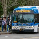 Riders board a Community Transit Route 116 bus Jan. 6 in front of Edmonds-Woodway High School in Edmonds. The route would be replaced by other service in a major overhaul phased in over 2024 and beyond. (Ryan Berry / Herald file)