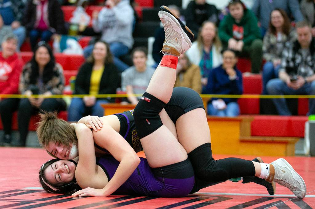 Lake Stevens Madisen Bowers calmly pins teammate Olivia Aylesworth to claim first place as the two laugh about it during the 3A/4A Girls Region 1 Wrestling Tournament on Saturday, Feb. 11, 2023, at Snohomish High School in Snohomish, Washington. (Ryan Berry / The Herald)