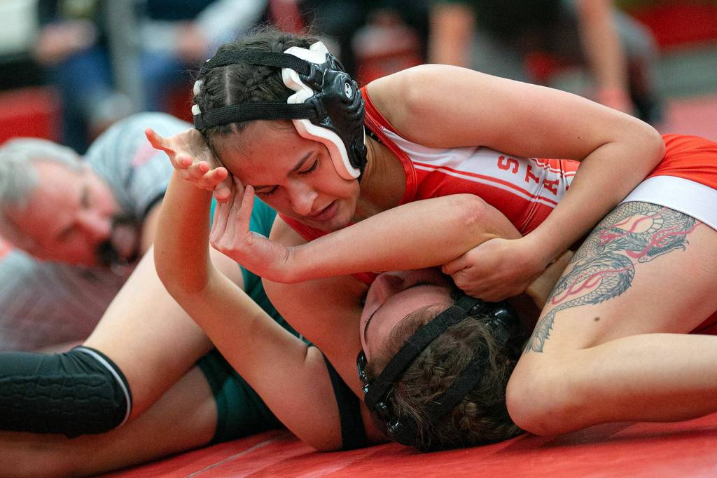 Stanwoods Laela Ridgeway records a victory by pinning Mount Vernons Braelyn Manke during the 3A/4A Girls Region 1 Wrestling Tournament on Saturday, Feb. 11, 2023, at Snohomish High School in Snohomish, Washington. (Ryan Berry / The Herald)