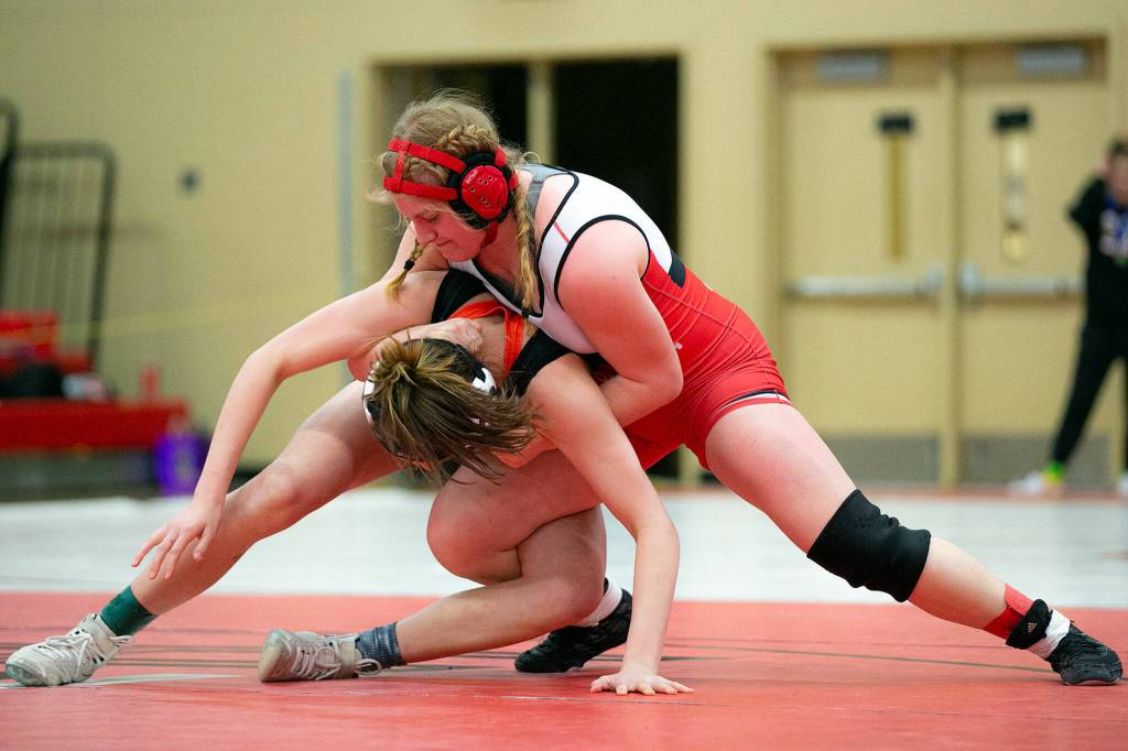 Snohomishs Jillian Hradec tries to keep down Bellinghams Frances Porteous during the 3A/4A Girls Region 1 Wrestling Tournament on Saturday, Feb. 11, 2023, at Snohomish High School in Snohomish, Washington. (Ryan Berry / The Herald)