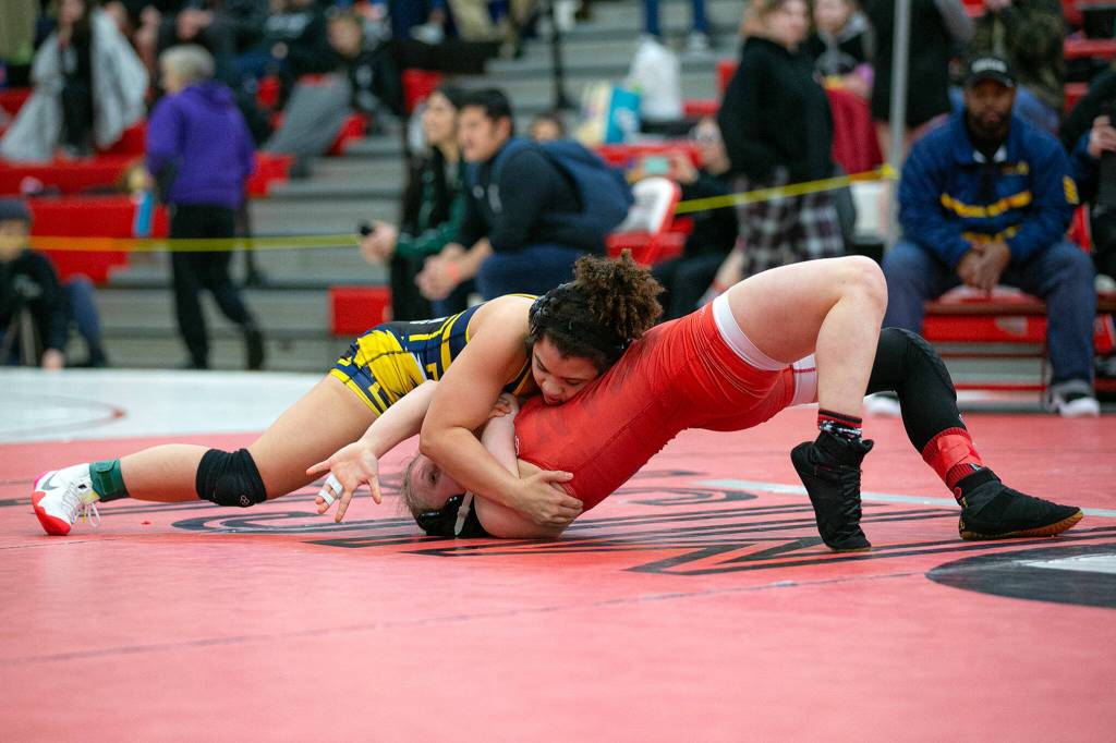 Ferndales Malia Welch quickly pins Snohomishs Signe Cairus during the 3A/4A Girls Region 1 Wrestling Tournament on Saturday, Feb. 11, 2023, at Snohomish High School in Snohomish, Washington. (Ryan Berry / The Herald)