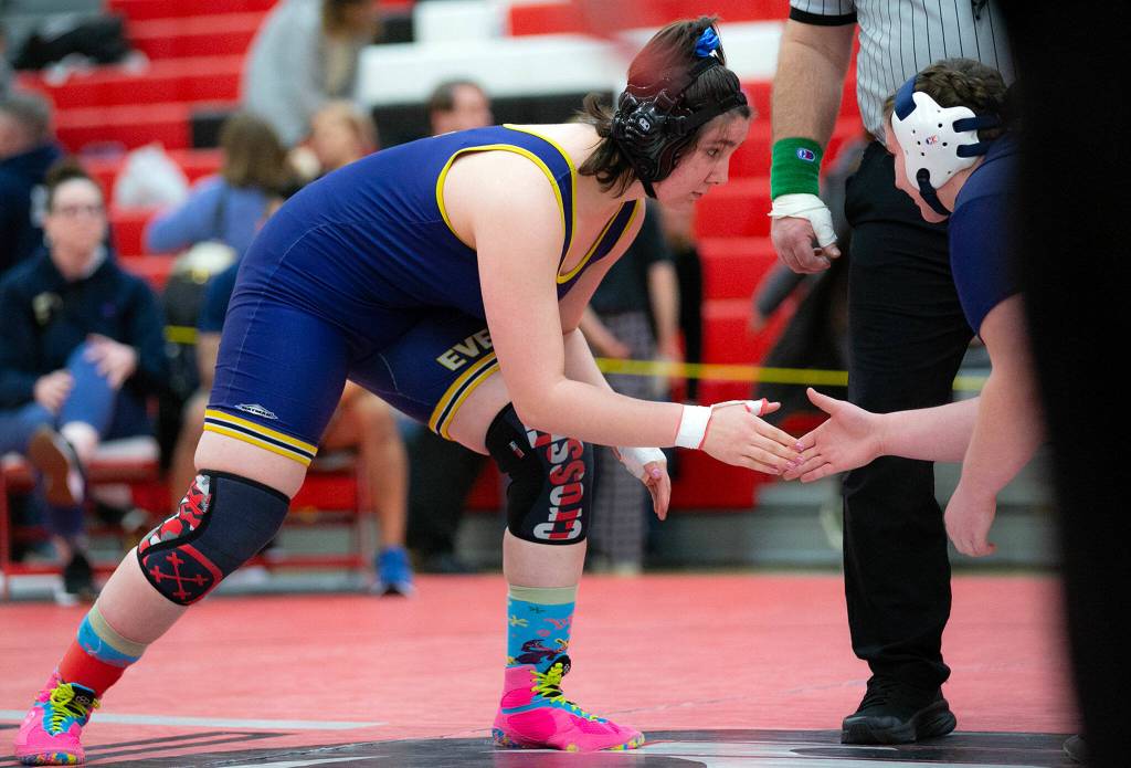 Everetts Mia Cienega shakes hands with Arlingtons Janay Beckman before claiming a victory by pin during the 3A/4A Girls Region 1 Wrestling Tournament on Saturday, Feb. 11, 2023, at Snohomish High School in Snohomish, Washington. (Ryan Berry / The Herald)