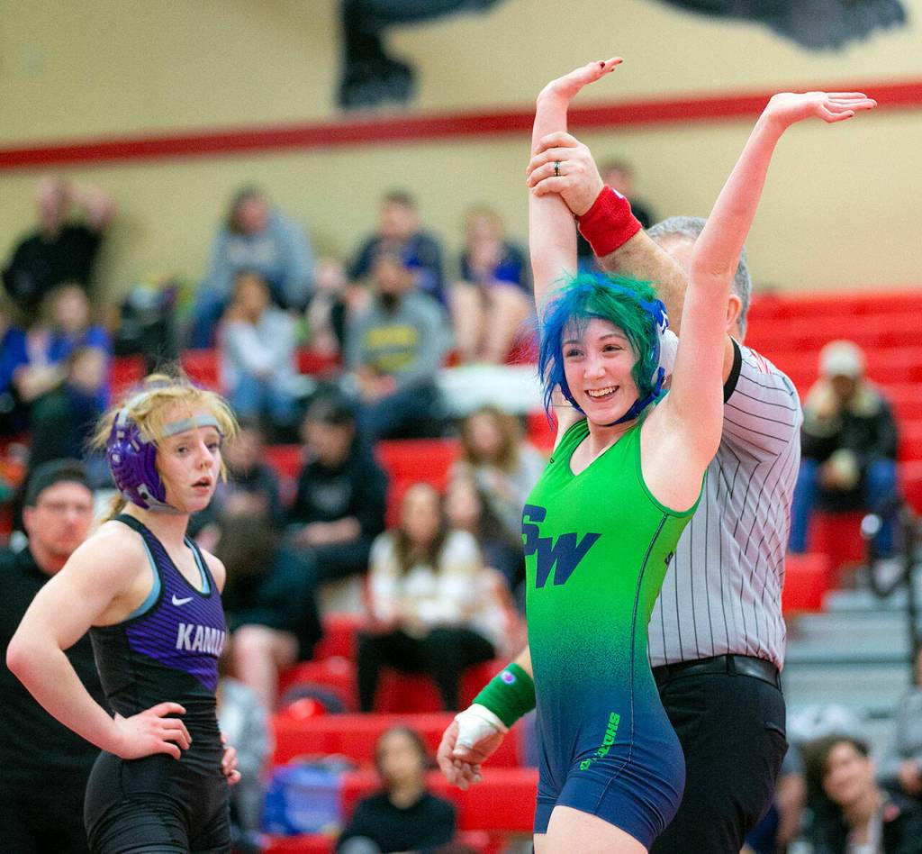 Shorewoods Finley Houck celebrates a first place finish in the 105 weight class during the 3A/4A Girls Region 1 Wrestling Tournament on Saturday, Feb. 11, 2023, at Snohomish High School in Snohomish, Washington. (Ryan Berry / The Herald)