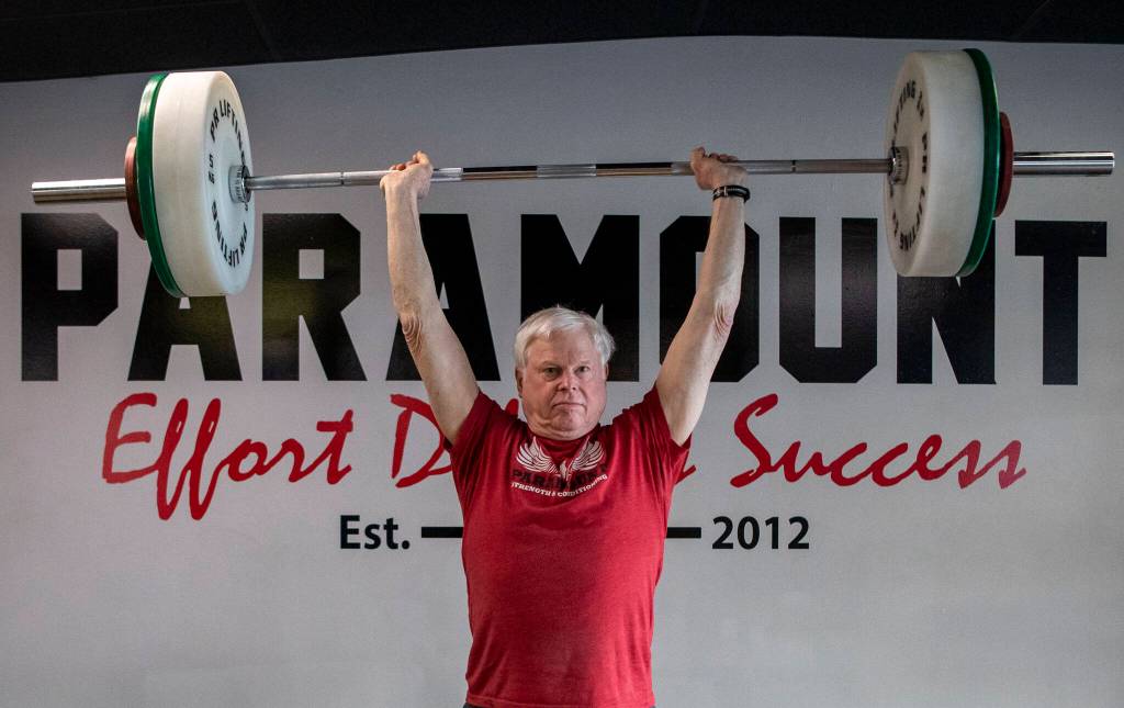 Phil Arnold, 74, practices his lifting techniques at Paramount Strength and Conditioning in Mountlake Terrace, Washington on Thursday, Feb. 2, 2023. The Edmonds resident is 74 and recently retired as an attorney. He took up weightlifting after retirement and recently won a national championship. (Annie Barker / The Herald)