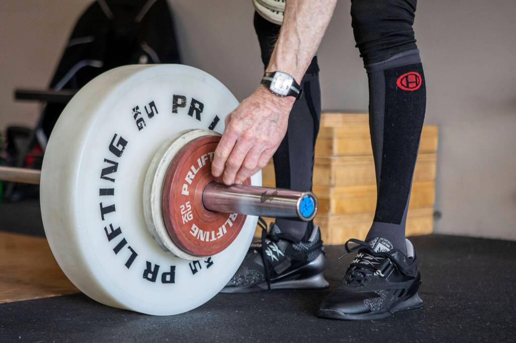 Phil Arnold, 74, practices his lifting techniques at Paramount Strength and Conditioning in Mountlake Terrace, Washington on Thursday, Feb. 2, 2023. The Edmonds resident is 74 and recently retired as an attorney. He took up weightlifting after retirement and recently won a national championship. (Annie Barker / The Herald)