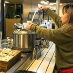 Suzie Zhu serves herself Ivar's clam chowder on the Edmonds-Kingston ferry run. The floating food courts offer a variety of Washington products, including sandwiches, beer, wine and ice cream. Ivar's chowder and chili is $4.50 to $5.75. (Kevin Clark / The Herald)