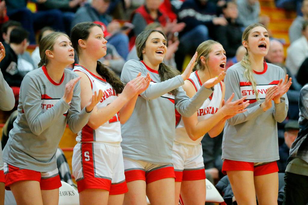 Stanwoods bench cheers on their team in a win over Snohomish on Tuesday, Feb. 14, 2023, at Marysville Pilchuck High School in Marysville, Washington. (Ryan Berry / The Herald)