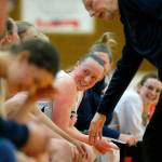 The Arlington bench all laugh as head coach Joe Marsh chooses five substitutes for his starters in the final minute of a win against Lynnwood on Tuesday, Feb. 14, 2023, at Marysville Pilchuck High School in Marysville, Washington. (Ryan Berry / The Herald)