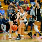 Arlingtons Samara Morrow passes down low to a teammate against Lynnwood on Tuesday, Feb. 14, 2023, at Marysville Pilchuck High School in Marysville, Washington. (Ryan Berry / The Herald)
