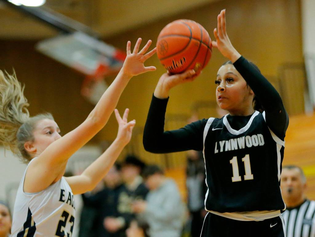 Lynnwoods Teyah Clark hits a three from the corner against Arlington on Tuesday, Feb. 14, 2023, at Marysville Pilchuck High School in Marysville, Washington. (Ryan Berry / The Herald)