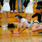 Arlingtons Maddy Fischer hits the deck after getting fouled on a loose ball against Lynnwood on Tuesday, Feb. 14, 2023, at Marysville Pilchuck High School in Marysville, Washington. (Ryan Berry / The Herald)