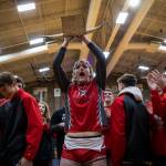 Stanwoods Elijah Fleck lifts the Battle of the Bull trophy in celebration of beating Arlington on Jan. 24 in Arlington. (Olivia Vanni / The Herald)