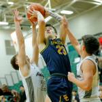 Shorecrests Parker Baumann draws a shooting foul against Arlington on Wednesday, Feb. 15, 2023, at Jackson High School in Mill Creek, Washington. (Ryan Berry / The Herald)