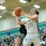 Arlingtons Leyton Martin goes for a windmill layup against Shorecrest on Wednesday, Feb. 15, 2023, at Jackson High School in Mill Creek, Washington. (Ryan Berry / The Herald)