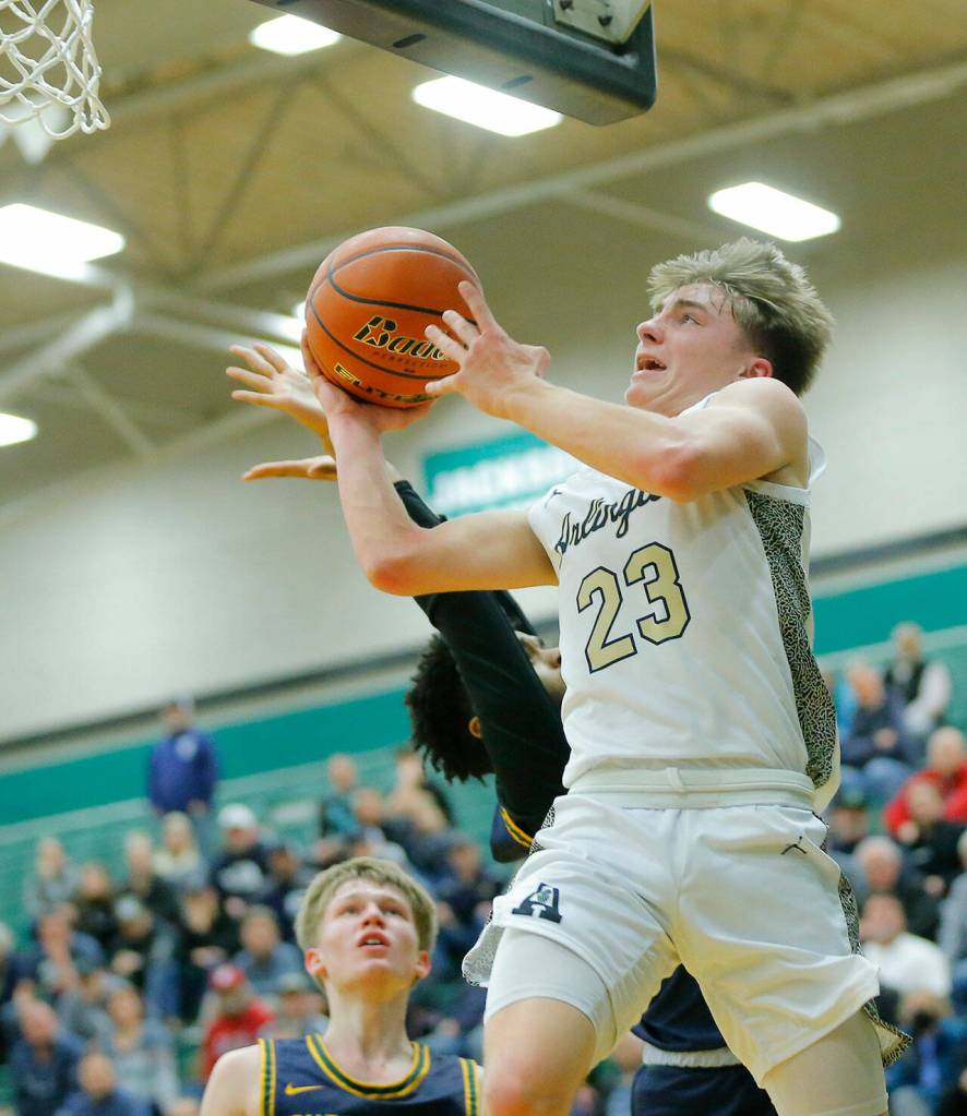 Arlingtons Leyton Martin goes for a windmill layup against Shorecrest on Wednesday, Feb. 15, 2023, at Jackson High School in Mill Creek, Washington. (Ryan Berry / The Herald)