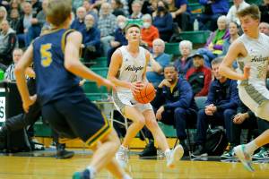 Arlington’s Ty Rusko steps into a three in transition against Shorecrest on Wednesday, Feb. 15, 2023, at Jackson High School in Mill Creek, Washington. (Ryan Berry / The Herald)