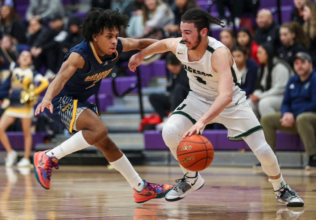 Mariners Jailin Johnson (2) and Jacksons Trey Hawkins (3) fight for the ball during a game between Jackson and Mariner at Lake Washington High School in Kirkland, Washington on Thursday, Feb. 16, 2023. After an intense back-and-forth in the final period Mariner defeated Jackson, 77-76. (Annie Barker / The Herald)