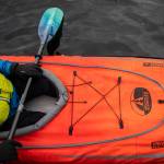 Ellingson sits in his Advanced Elements kayak, one of the kayaks he will be bringing with him on his trip along the Mekong on Saturday, Feb. 18, in Mountlake Terrace. (Olivia Vanni / The Herald)