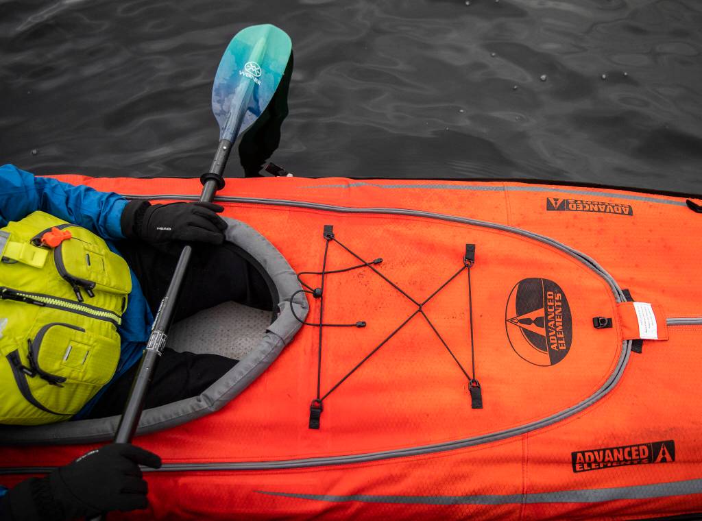 Ellingson sits in his Advanced Elements kayak, one of the kayaks he will be bringing with him on his trip along the Mekong on Saturday, Feb. 18, in Mountlake Terrace. (Olivia Vanni / The Herald)