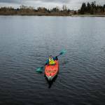 Dave Ellingson, 25, paddles around Lake Ballinger for practice on Saturday, Feb. 18, 2023 in Mountlake Terrace, Washington. (Olivia Vanni / The Herald)