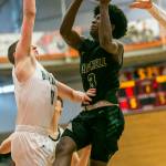 Marysville-Getchells Shawn Etheridge attempts a layup while being guarded during the game against Mount Vernon on Friday, Feb. 17, 2023 in Everett, Washington. (Olivia Vanni / The Herald)